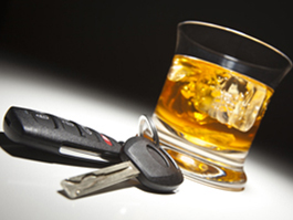 Car keys and glass of alcohol